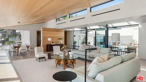 a kitchen with stainless steel appliances a sink and a large window