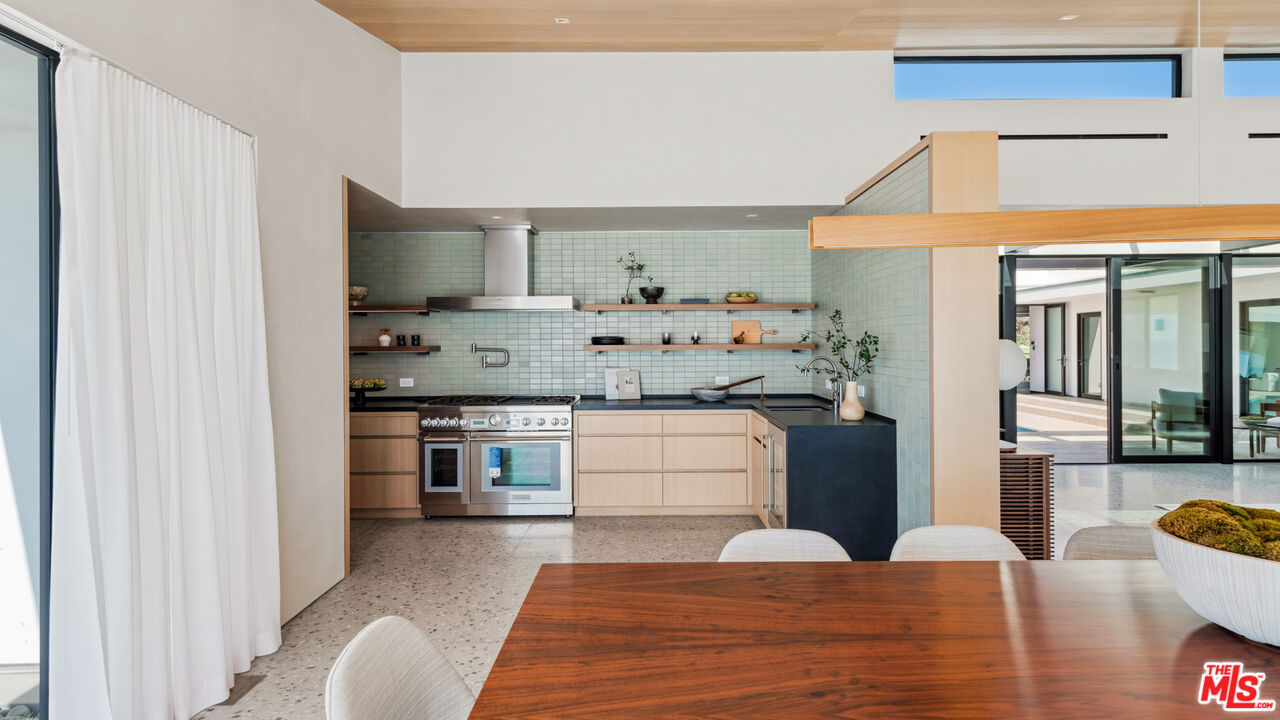 31388 Broad Beach Road Malibu, CA 90265 - Photo 28 of 74 a kitchen with stainless steel appliances kitchen island granite countertop a refrigerator and a stove top oven