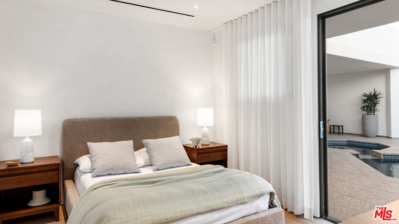 31388 Broad Beach Road Malibu, CA 90265 - Photo 56 of 74 a bedroom with a bed and a potted plant on the dresser