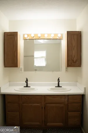 a bathroom with a sink vanity and a mirror