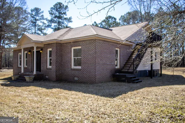 a view of a house with a snow in the yard
