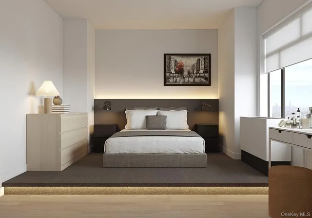 a bedroom with a large bed and a chandelier