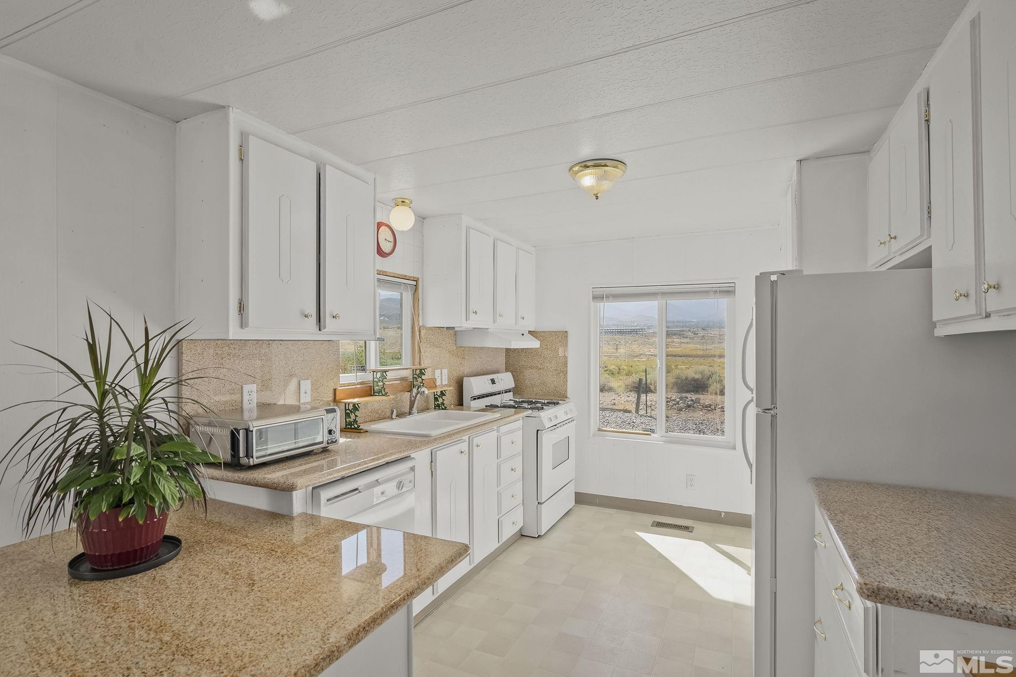 500 Mira Street Reno, NV 89521 - Photo 13 of 31 a kitchen with stainless steel appliances a counter space and a window