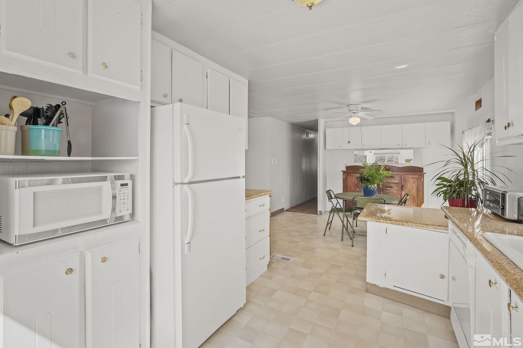 500 Mira Street Reno, NV 89521 - Photo 15 of 31 a view of a kitchen with furniture and a refrigerator