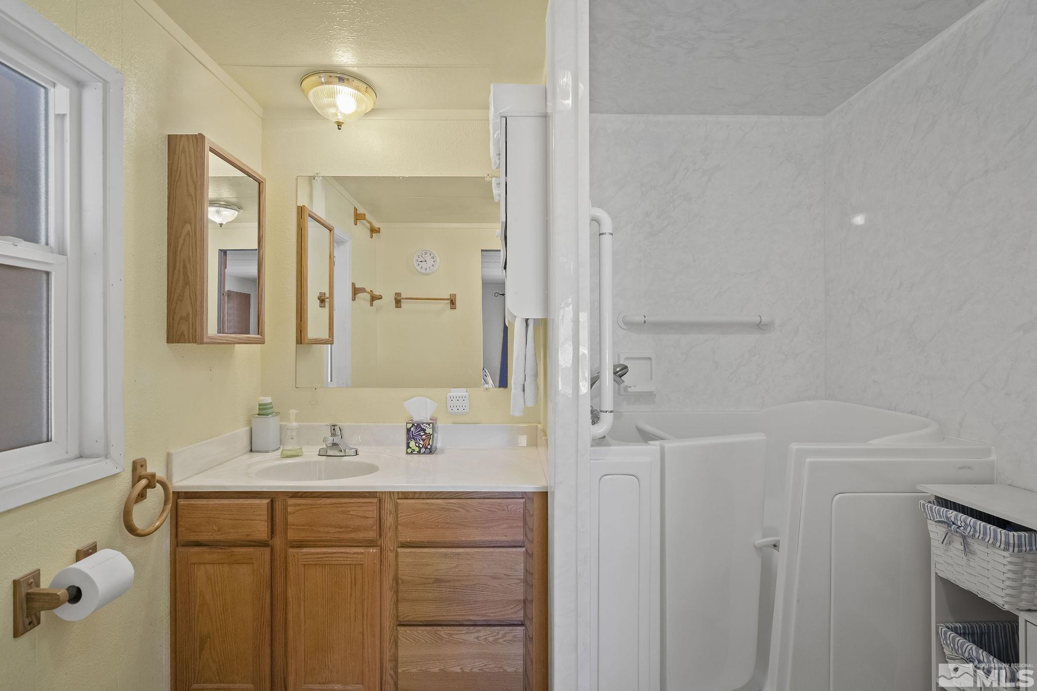 500 Mira Street Reno, NV 89521 - Photo 17 of 31 a bathroom with a sink mirror and a bathtub