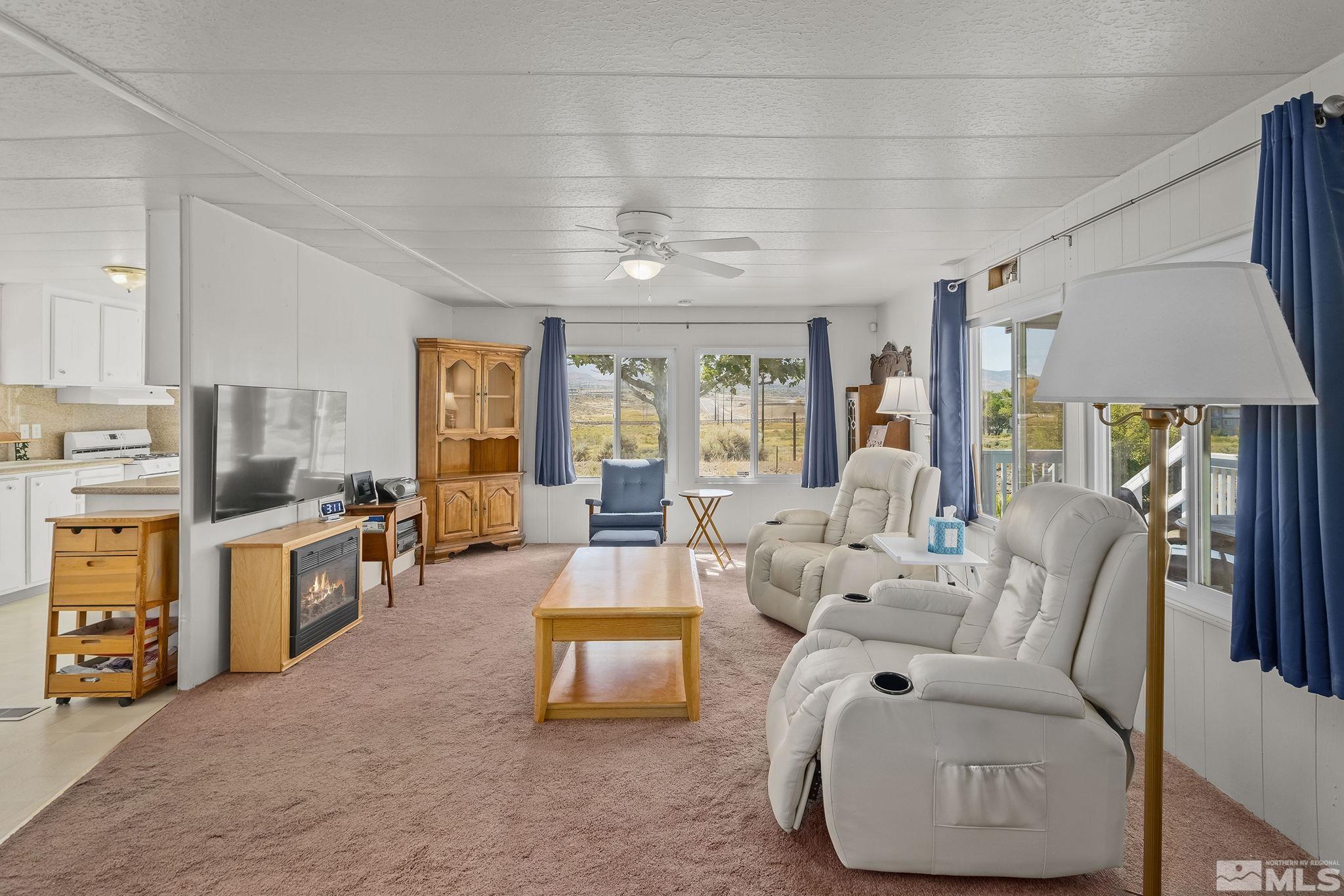 500 Mira Street Reno, NV 89521 - Photo 7 of 31 a living room with furniture and a chandelier
