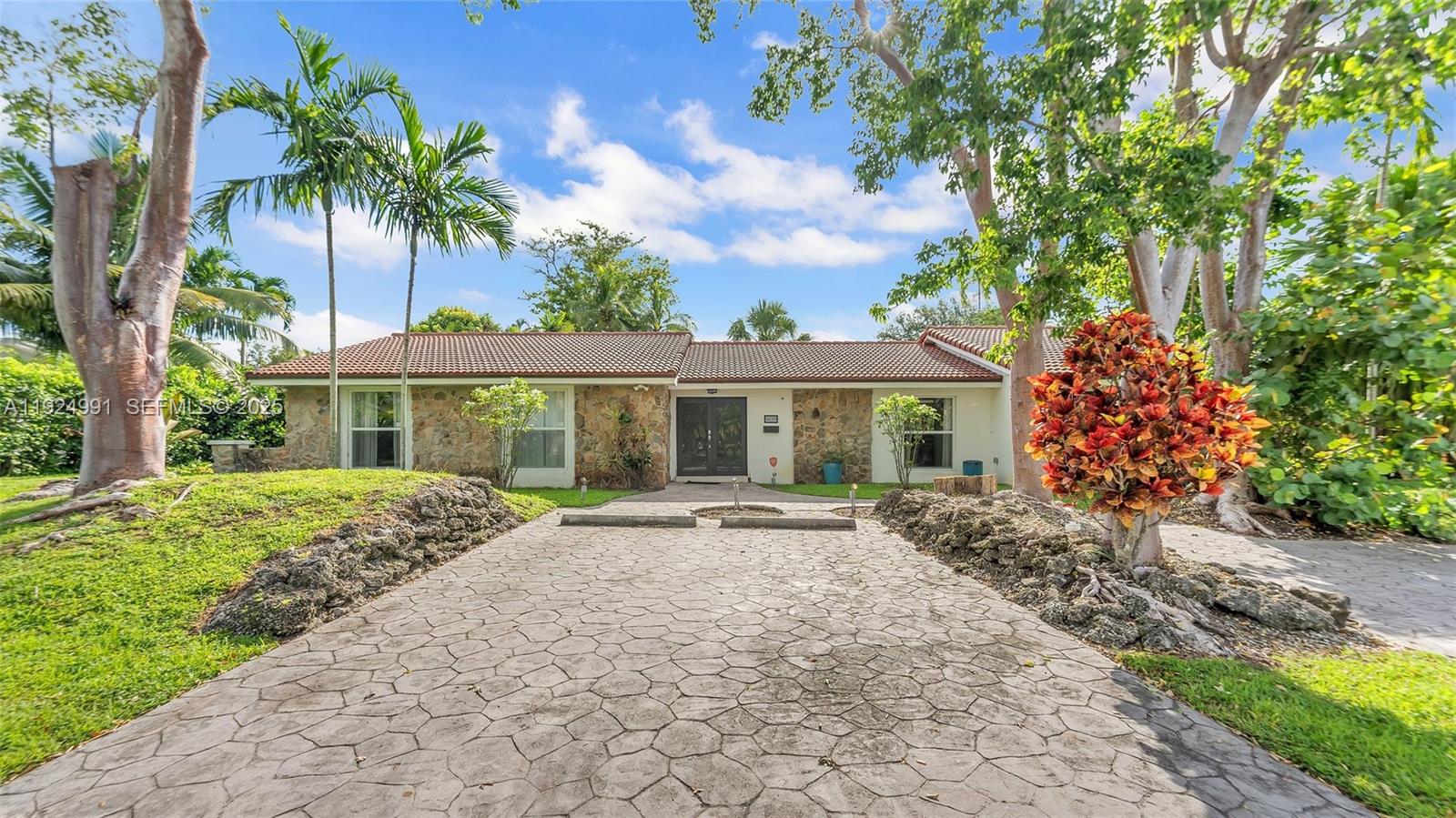 9220 Southwest 94th Place Miami, FL 33176 - Photo 1 of 67 a front view of a house with a garden
