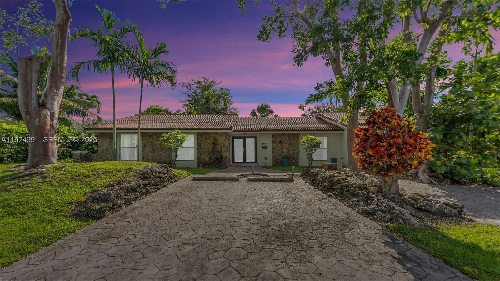 9220 Southwest 94th Place Miami, FL 33176 - Photo 16 of 67 a front view of a house with a garden and yard