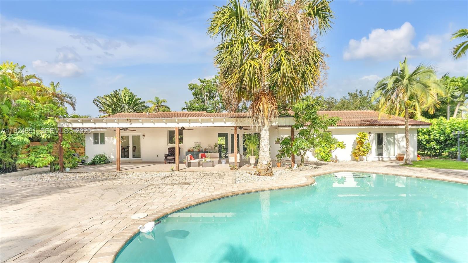 9220 Southwest 94th Place Miami, FL 33176 - Photo 2 of 67 a view of a house with a yard and sitting area