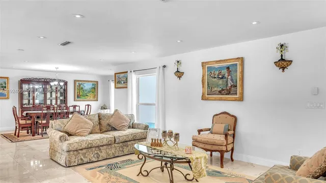 a view of a dining room with furniture wooden floor and chandelier