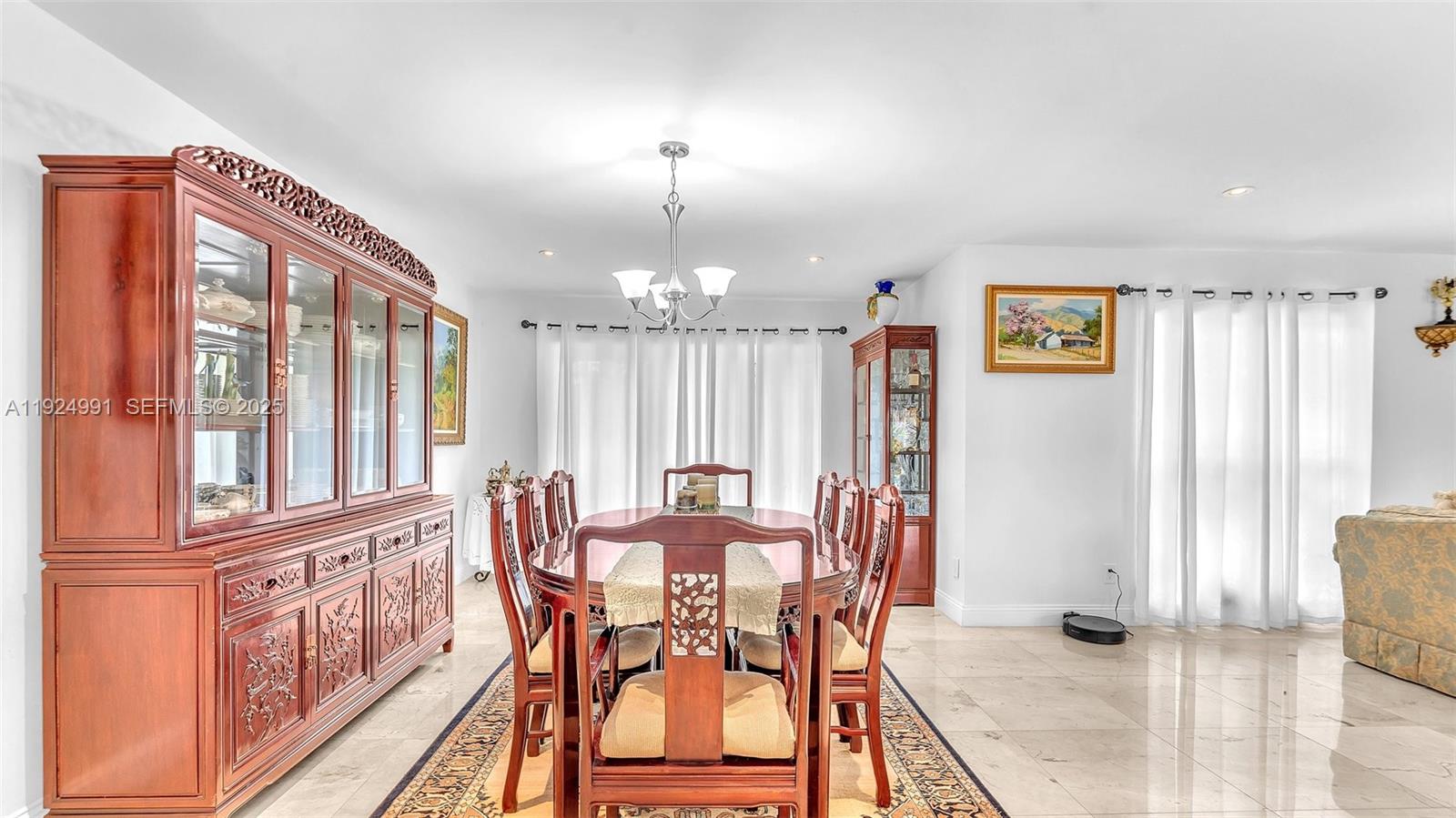 9220 Southwest 94th Place Miami, FL 33176 - Photo 22 of 67 a view of a dining room with furniture window and wooden floor