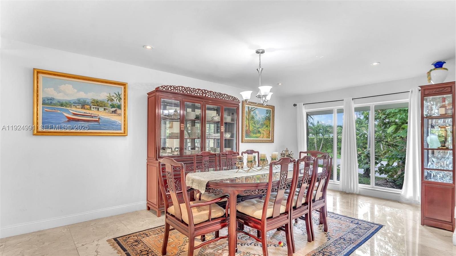 9220 Southwest 94th Place Miami, FL 33176 - Photo 24 of 67 a view of a dining room with furniture wooden floor and chandelier