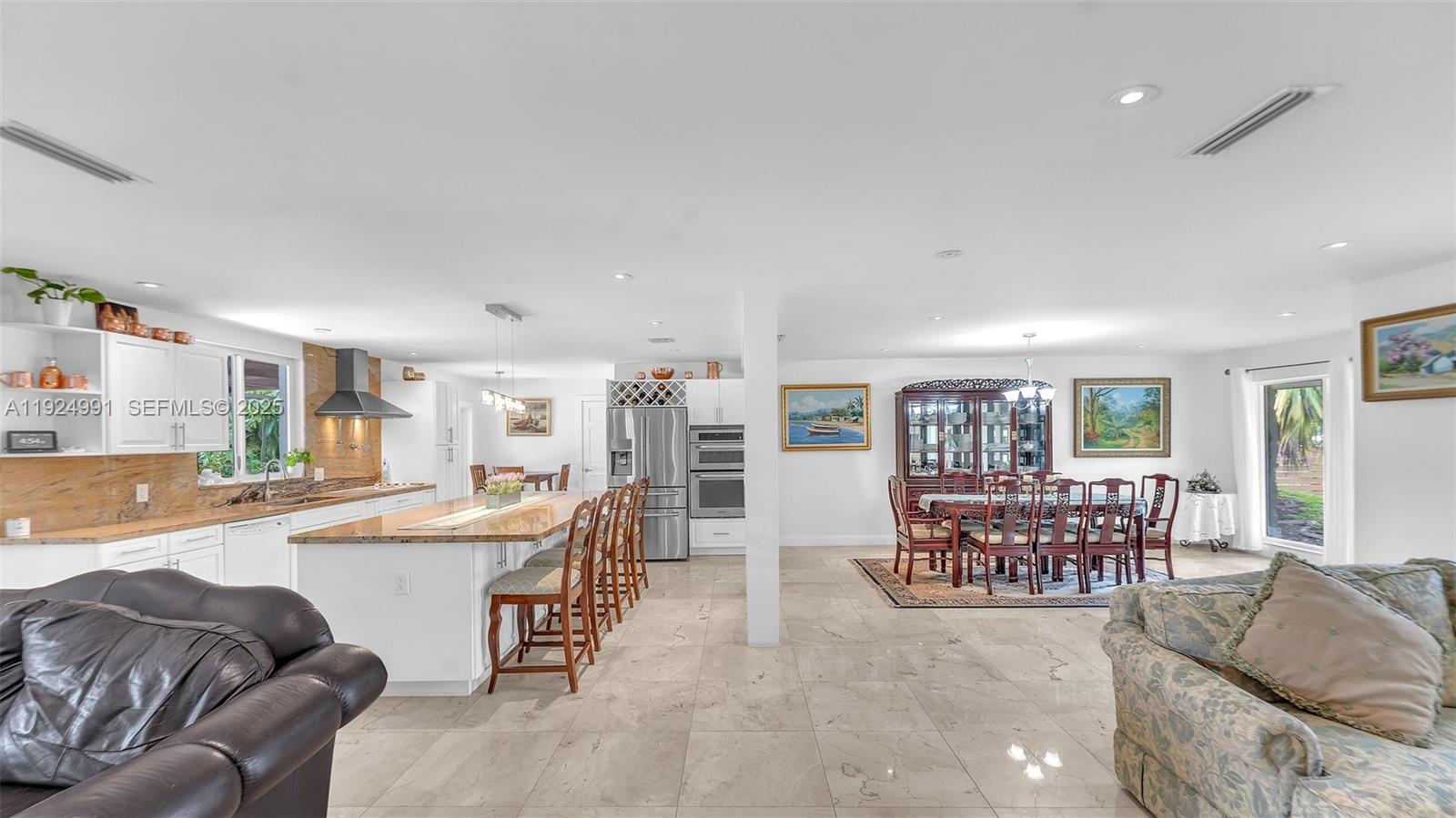 9220 Southwest 94th Place Miami, FL 33176 - Photo 27 of 67 a large living room with stainless steel appliances granite countertop a couch and a large window