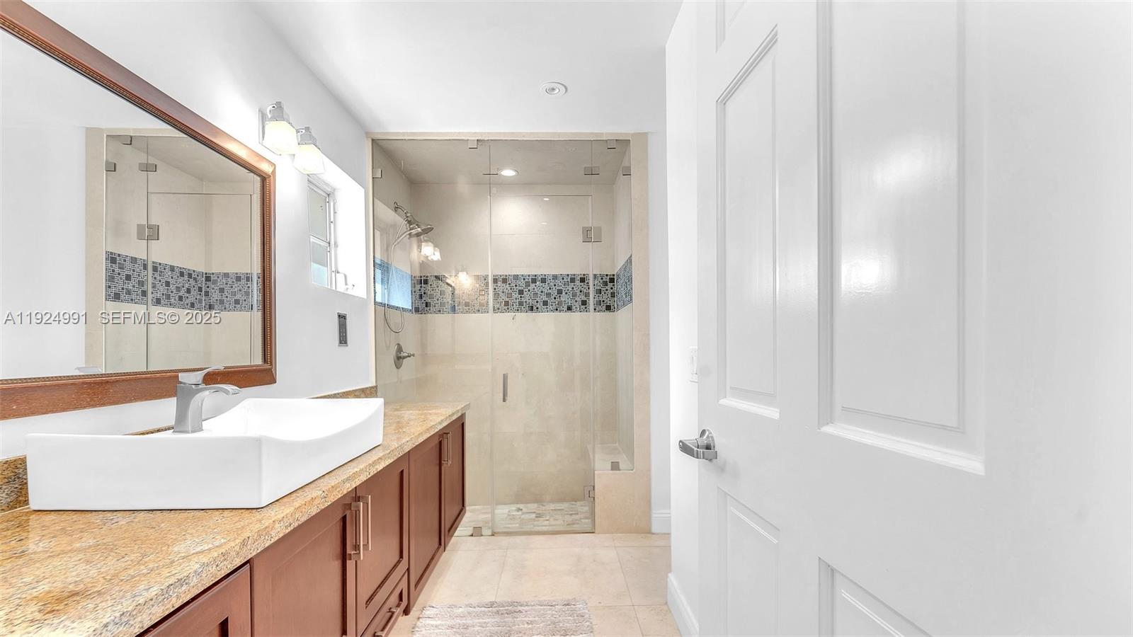 9220 Southwest 94th Place Miami, FL 33176 - Photo 39 of 67 a bathroom with a double vanity sink a mirror and a shower