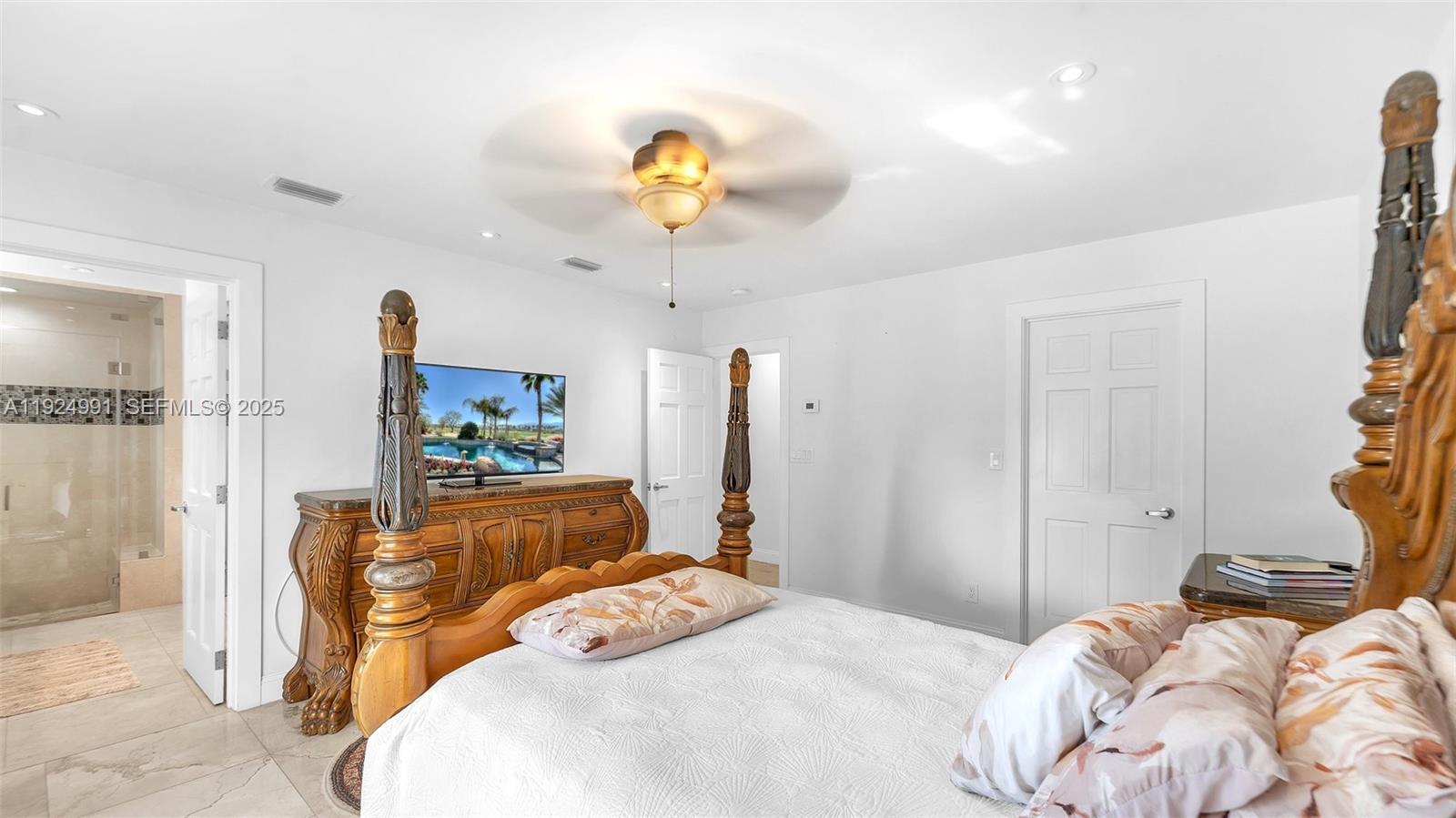 9220 Southwest 94th Place Miami, FL 33176 - Photo 41 of 67 a bedroom with a bed and a chandelier