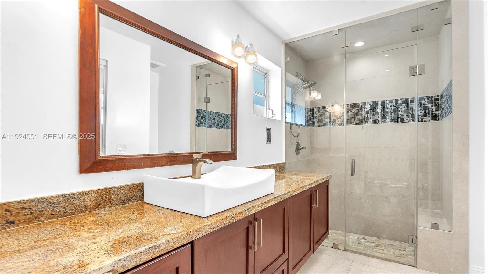 9220 Southwest 94th Place Miami, FL 33176 - Photo 42 of 67 a bathroom with a granite countertop sink mirror and double