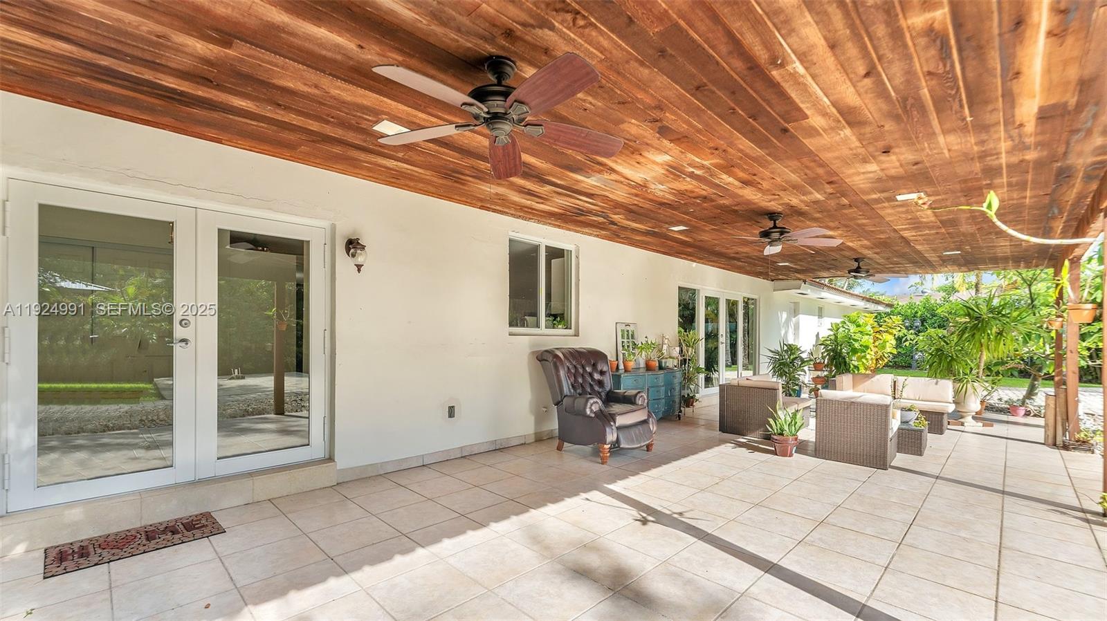 9220 Southwest 94th Place Miami, FL 33176 - Photo 48 of 67 a building outdoor space with patio furniture and potted plants