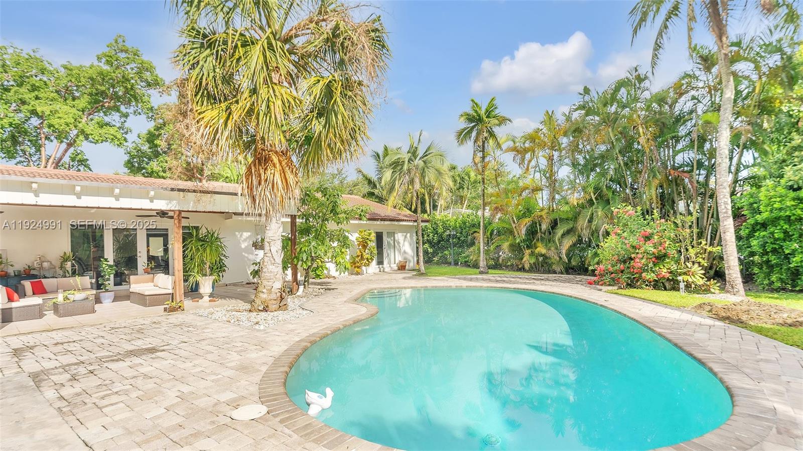 9220 Southwest 94th Place Miami, FL 33176 - Photo 51 of 67 a view of a swimming pool with a patio and plants