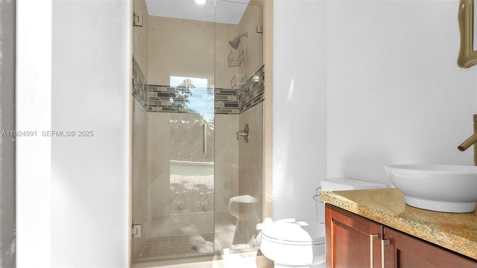 9220 Southwest 94th Place Miami, FL 33176 - Photo 55 of 67 a bathroom with a granite countertop sink a toilet and shower