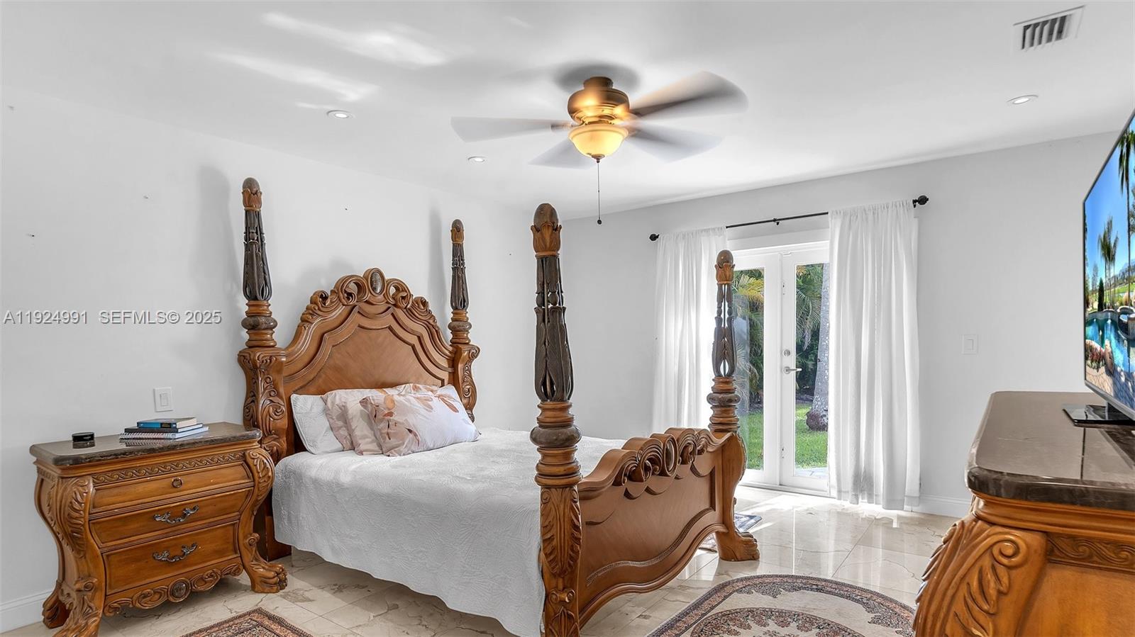 9220 Southwest 94th Place Miami, FL 33176 - Photo 6 of 67 a living room with furniture and a chandelier