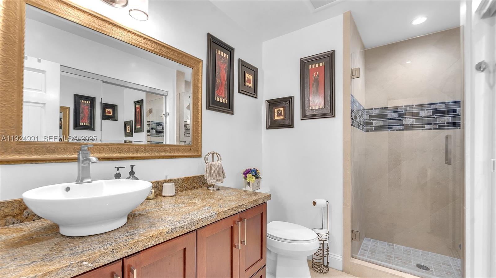 9220 Southwest 94th Place Miami, FL 33176 - Photo 7 of 67 a bathroom with a granite countertop sink toilet and shower