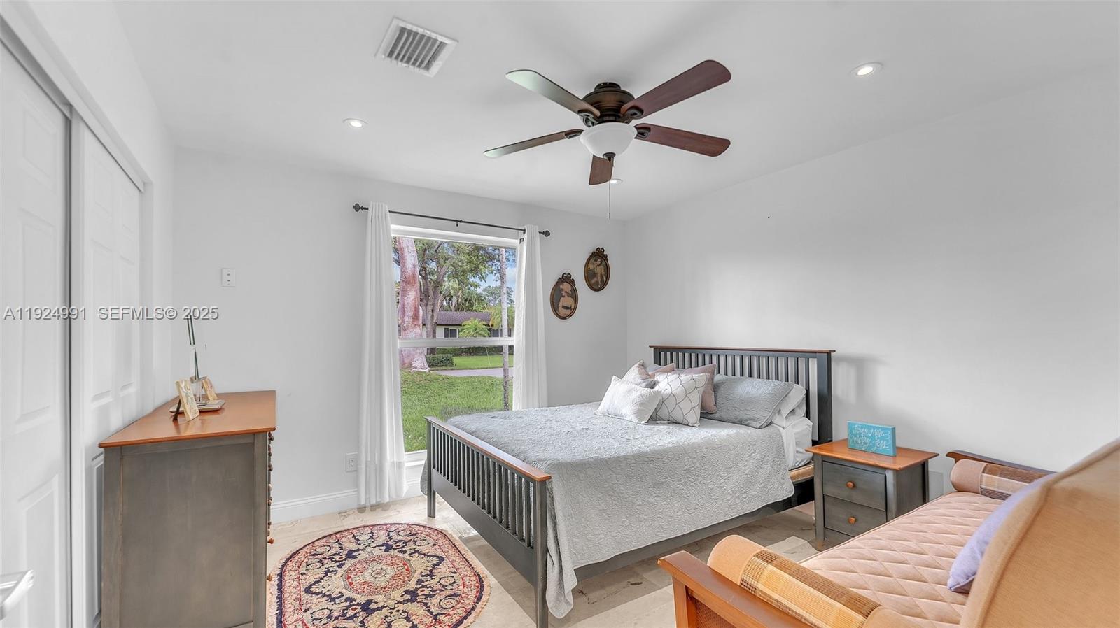 9220 Southwest 94th Place Miami, FL 33176 - Photo 8 of 67 a bedroom with a bed and a chandelier