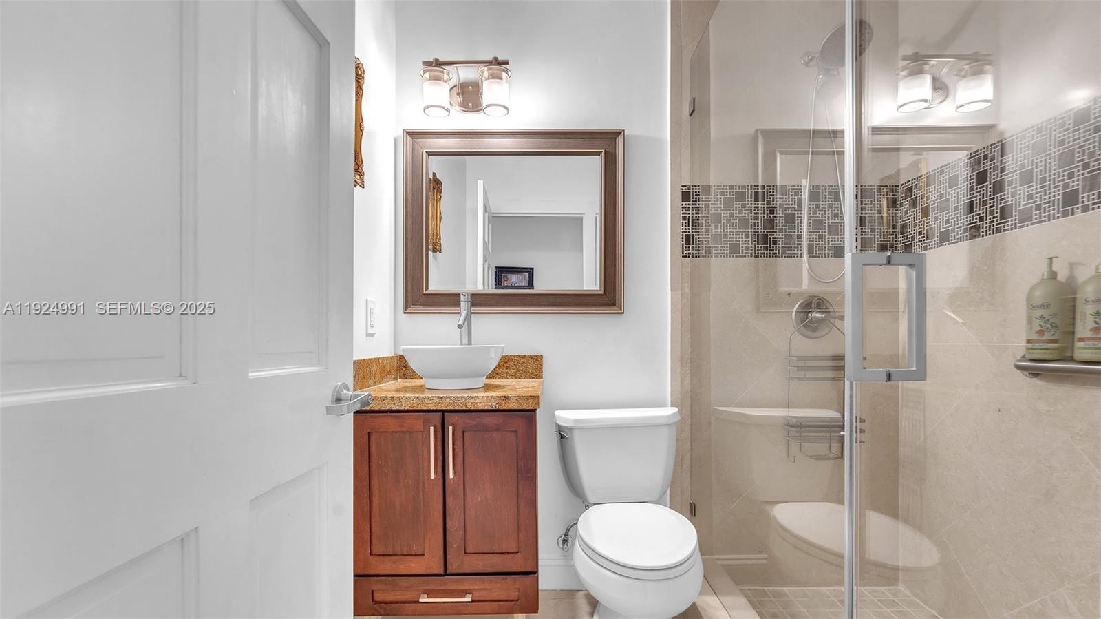 9220 Southwest 94th Place Miami, FL 33176 - Photo 9 of 67 a bathroom with a toilet a sink and mirror