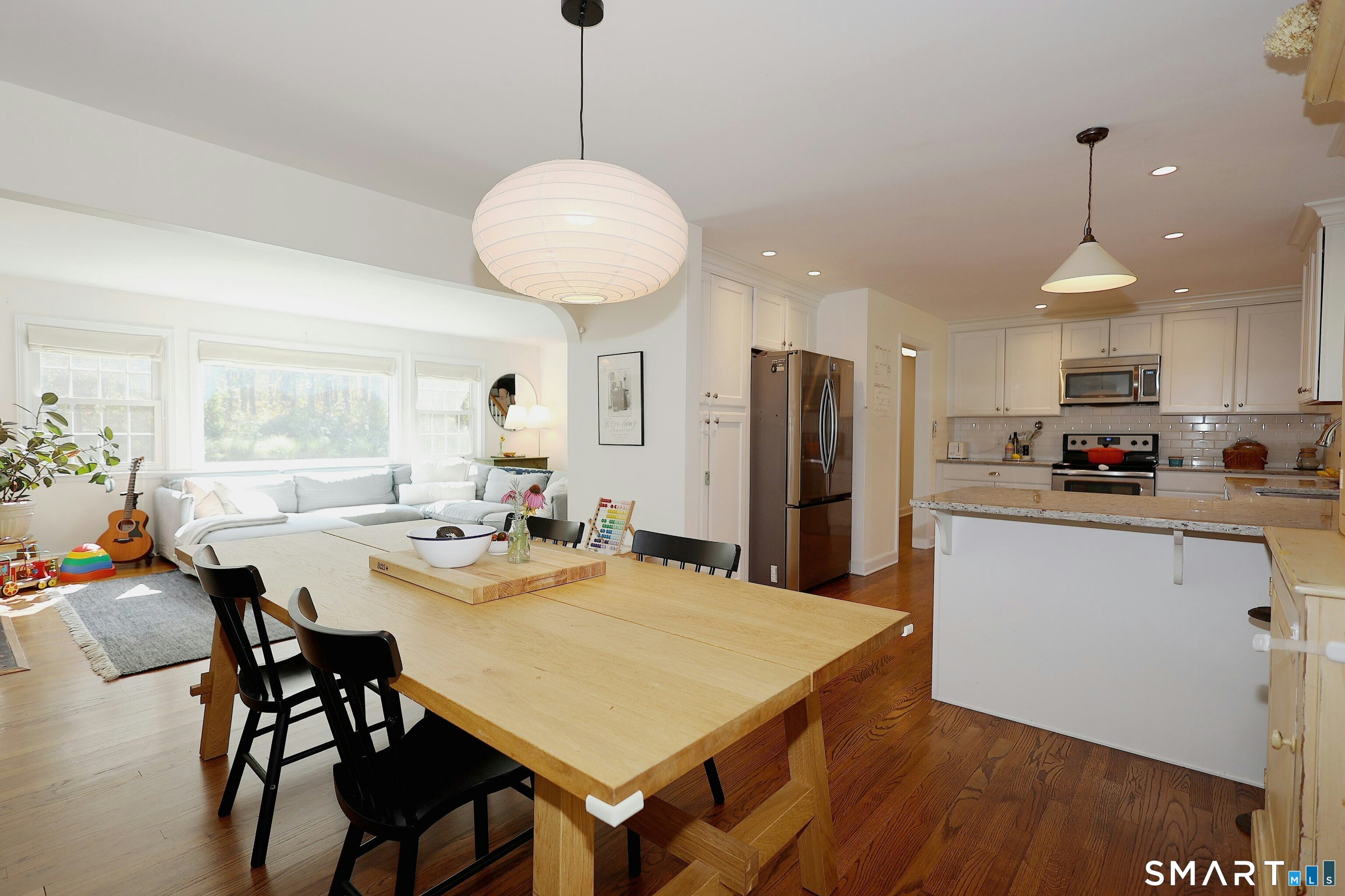 18 Head Of Meadow Road Newtown, CT 06470 - Photo 16 of 40 a kitchen with stainless steel appliances a dining table chairs and wooden floor