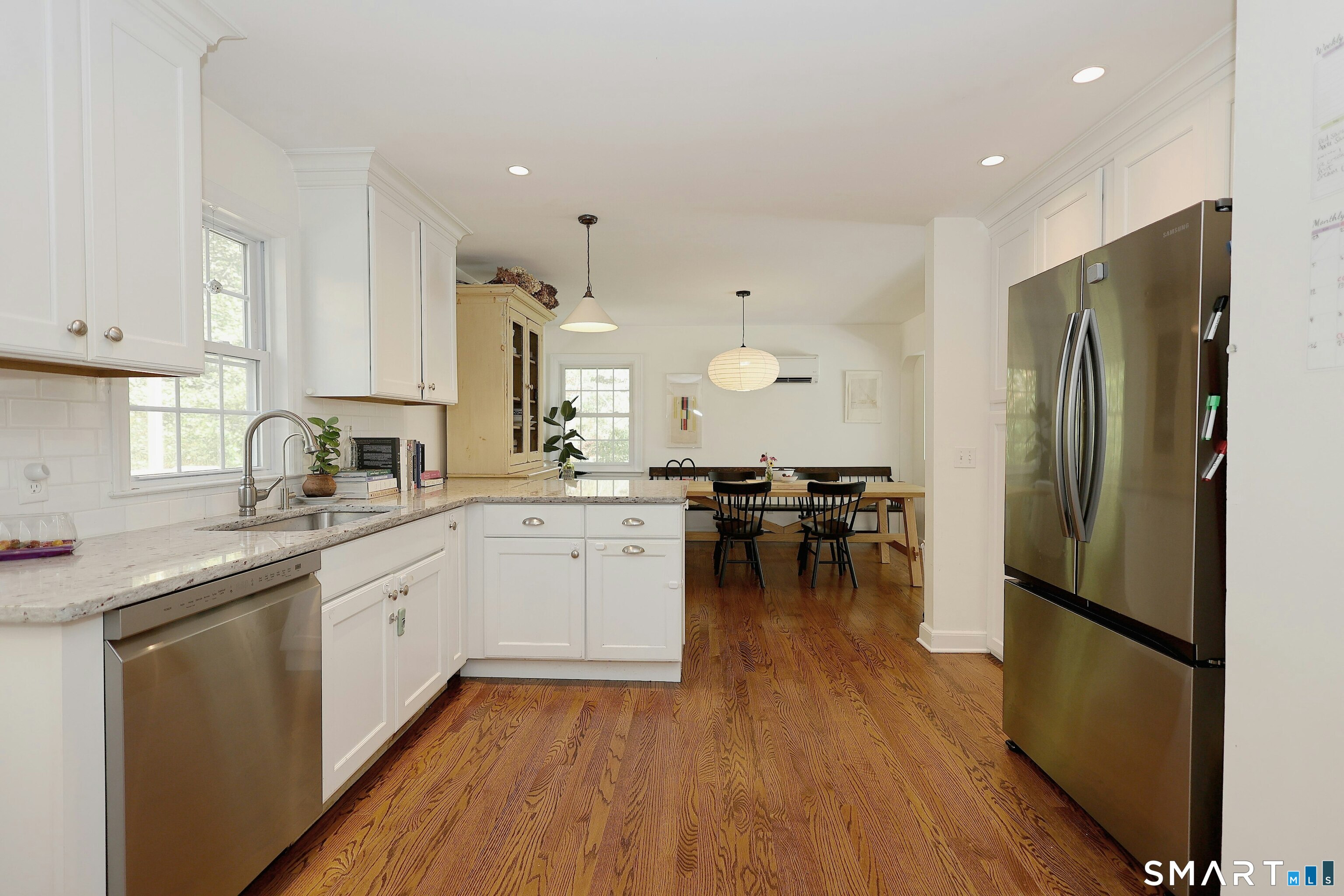 18 Head Of Meadow Road Newtown, CT 06470 - Photo 19 of 40 a kitchen with stainless steel appliances a refrigerator a sink dishwasher a stove and white cabinets with wooden floor