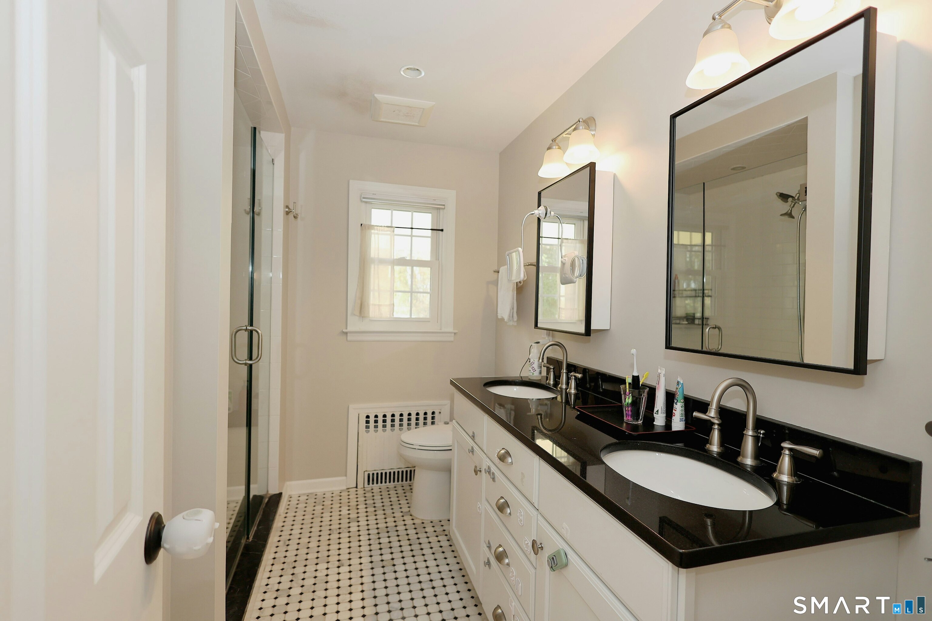 18 Head Of Meadow Road Newtown, CT 06470 - Photo 24 of 40 a bathroom with a sink double vanity granite and a mirror