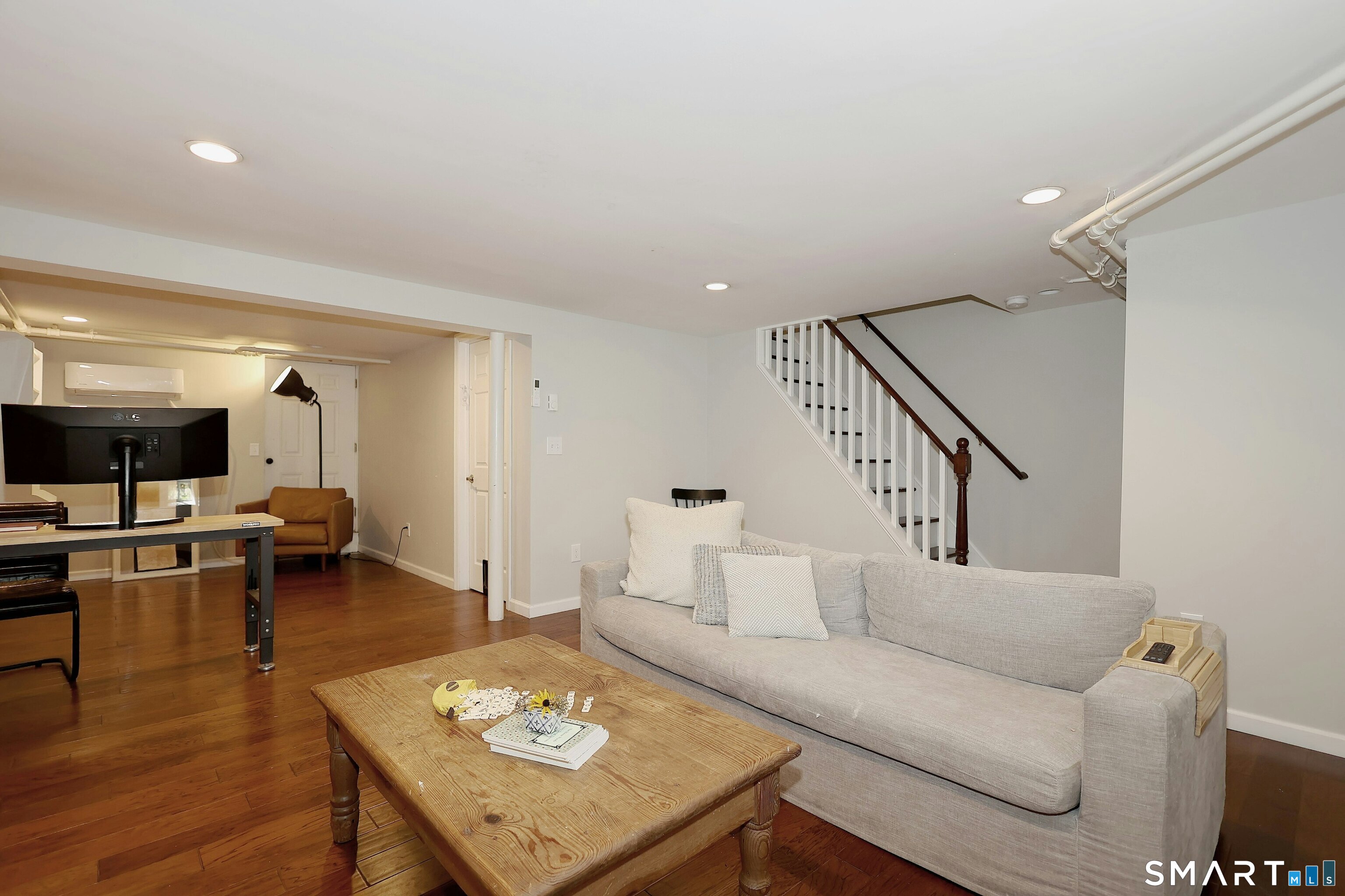 18 Head Of Meadow Road Newtown, CT 06470 - Photo 35 of 40 a living room with furniture and a flat screen tv