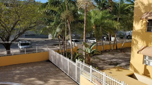 a view of a swimming pool with a patio and trees