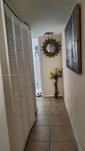 a view of hallway with furniture and a window