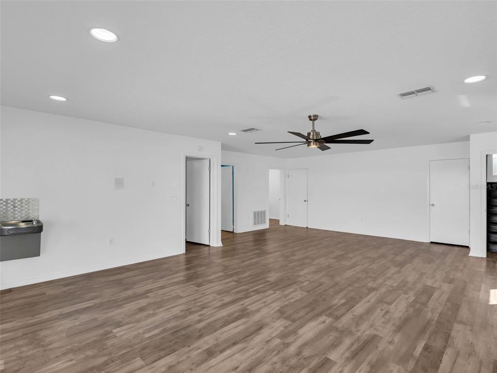 6241 Bayside Drive New Port Richey, FL 34652 - Photo 42 of 78 an empty room with wooden floor and windows