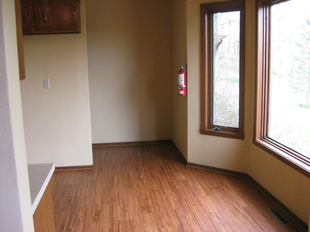 15351 Mill Road Capron, IL 61012 - Photo 7 of 20 an empty room with wooden floor and windows