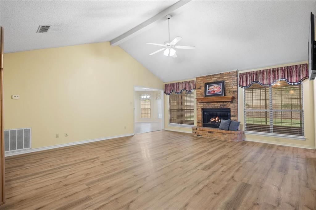 2824 Crestview Avenue Tyler, TX 75701 - Photo 6 of 39 an empty room with wooden floor fireplace and fan