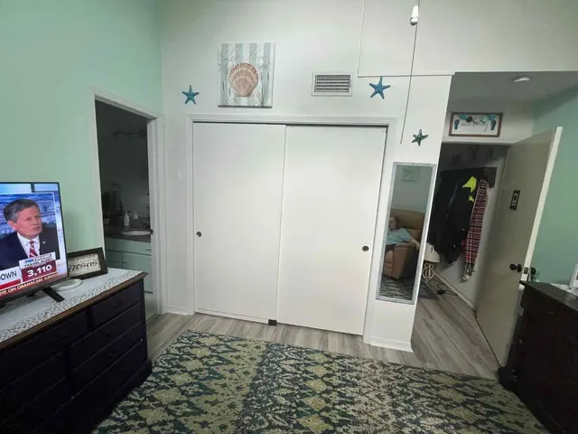 a bathroom with a refrigerator and a window