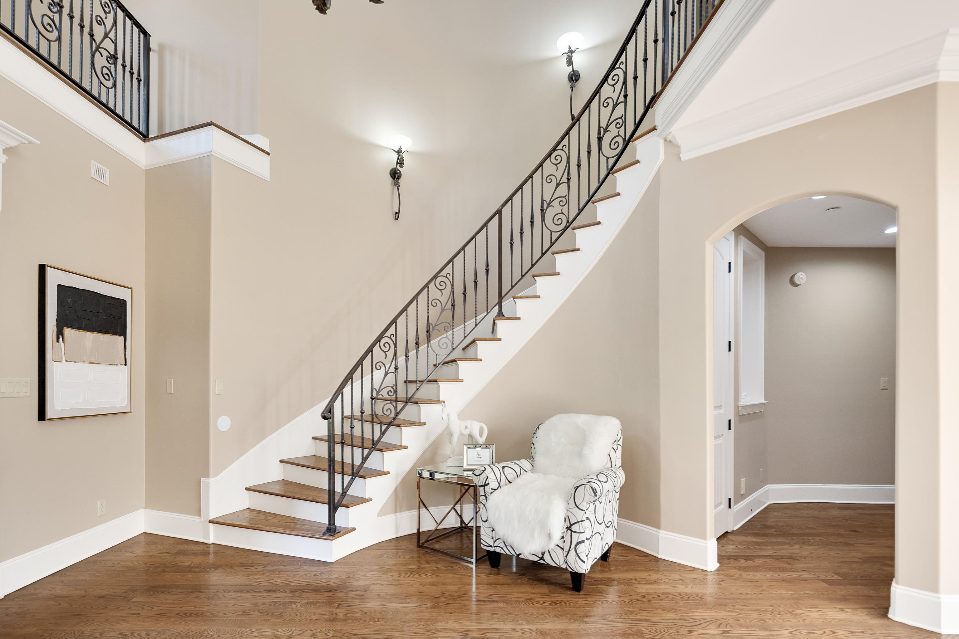 425 Buckland Cove Eads, TN 38028 - Photo 20 of 29 Stairs featuring a high ceiling, wood finished floors, and arched walkways
