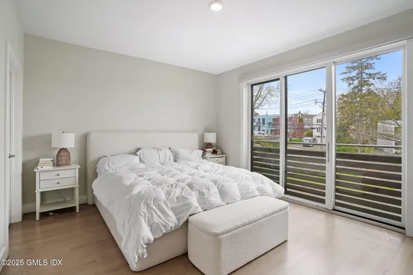 a bedroom with a bed and a large window