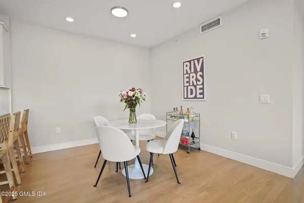 a view of a dining room with furniture and wooden floor