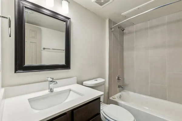a bathroom with a sink toilet tub and shower
