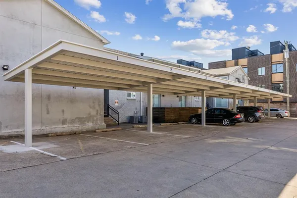 a view of a building with car parked
