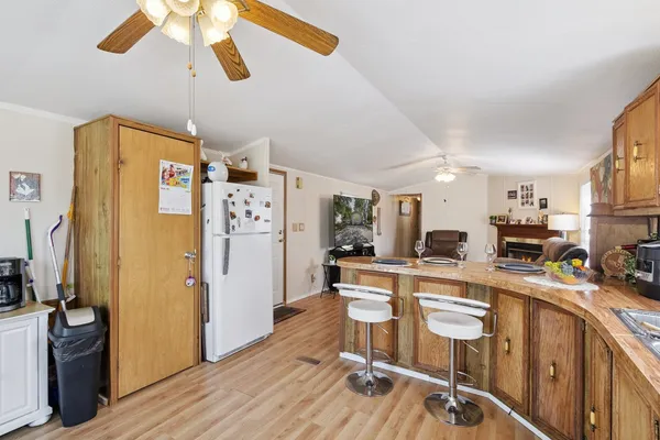 a kitchen with stainless steel appliances granite countertop a refrigerator and a stove top oven
