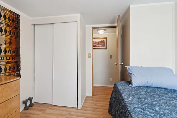 a bedroom with a bed and a book shelf
