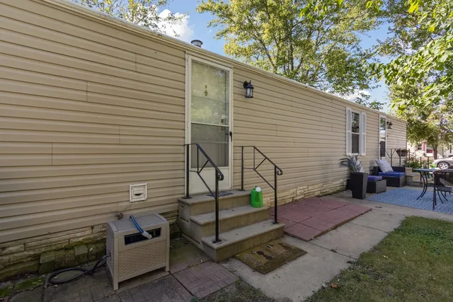 a view of a patio with table and chairs with wooden fence and plants