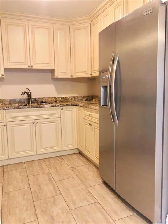 3502 Riverside Drive Coral Springs, FL 33065 - Photo 7 of 16 a kitchen with stainless steel appliances granite countertop a refrigerator a stove and a sink