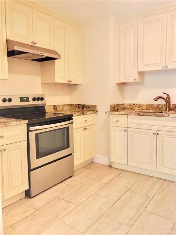 3502 Riverside Drive Coral Springs, FL 33065 - Photo 8 of 16 a kitchen with white cabinets and white appliances