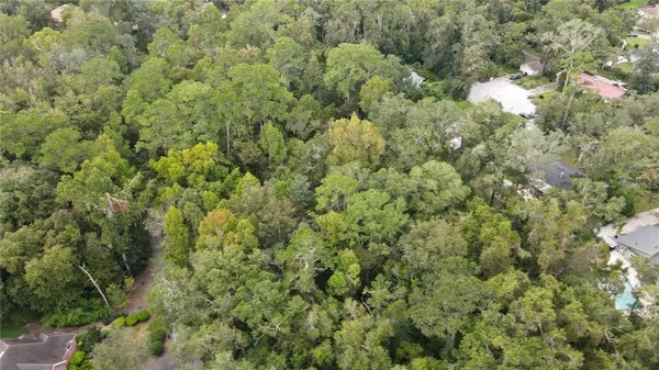 a view of a house with a street and trees