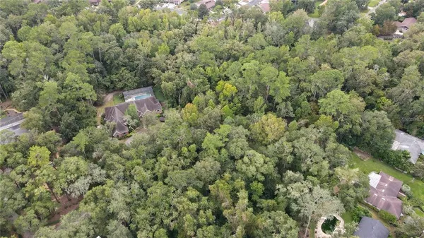 an aerial view of a house with yard