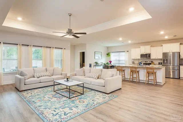 a living room with furniture and kitchen view